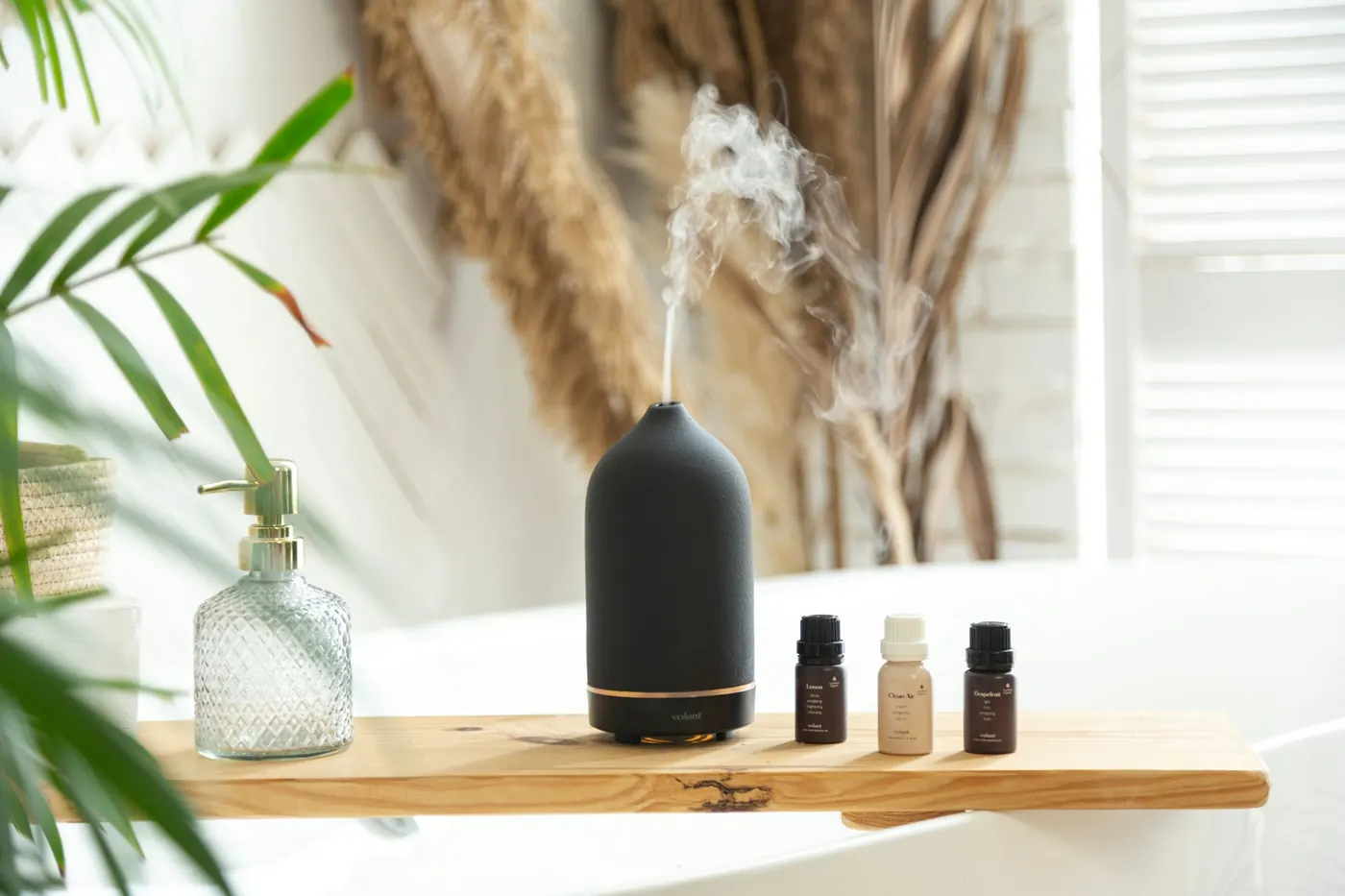 Suasana pijat aromaterapi dengan diffuser minyak esensial dan pencahayaan lembut.