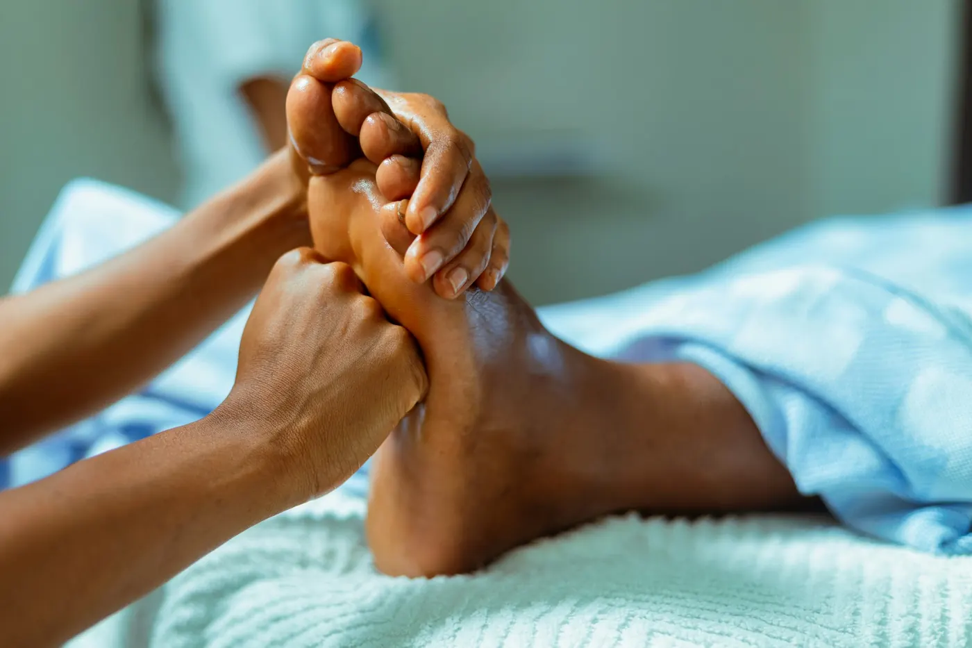 Terapis melakukan pijat refleksi pada kaki klien setelah sesi fullbody massage.